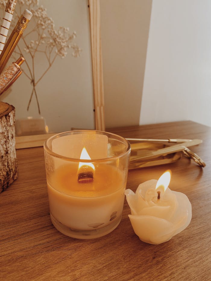 Warm, inviting tabletop featuring lit scented candles and delicate decor for relaxation.